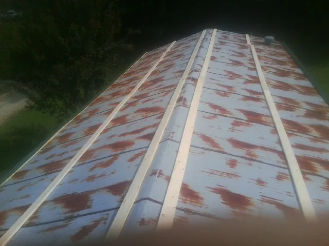 Rusted metal roof panels with new wood purlins before replacement — Storm Damage Roof Repair in Tabiona by Roofing Brothers